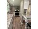 Well-lit kitchen featuring an island and a stainless steel oven at 4524 Cinderella Rd, Charlotte, NC 28213