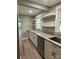 Renovated kitchen with granite countertops, stainless steel appliances, and floating shelves at 4524 Cinderella Rd, Charlotte, NC 28213