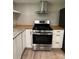 Kitchen featuring a stainless steel stove, hood, and wooden countertops at 4524 Cinderella Rd, Charlotte, NC 28213