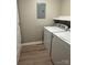 A basic laundry room with a washer, dryer, and shelving for storage at 4524 Cinderella Rd, Charlotte, NC 28213