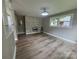 Living room featuring a decorative stone wall, fireplace, and large window at 4524 Cinderella Rd, Charlotte, NC 28213