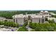 An aerial shot shows the beautiful city skyline with office buildings and lush green trees, adding charm to this commercial area at 4620 Piedmont Row Dr # 308, Charlotte, NC 28210