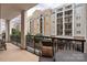 Outdoor balcony with seating area, offering a peaceful retreat with views of the surrounding buildings at 4620 Piedmont Row Dr # 308, Charlotte, NC 28210