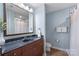 Bathroom featuring dark countertop, toilet, vanity, and a shower with white curtain at 4620 Piedmont Row Dr # 308, Charlotte, NC 28210