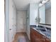 Bathroom with tile floor, single vanity, and multiple storage options at 4620 Piedmont Row Dr # 308, Charlotte, NC 28210