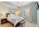 Charming bedroom with a comfortable bed, a bedside table with a lamp, and a window with a view at 4620 Piedmont Row Dr # 308, Charlotte, NC 28210