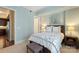 Bright bedroom featuring a floral patterned comforter and soft, neutral carpeting at 4620 Piedmont Row Dr # 308, Charlotte, NC 28210
