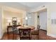 Cozy dining area with hardwood floors, stylish table, and chairs, next to a beautifully decorated console table at 4620 Piedmont Row Dr # 308, Charlotte, NC 28210
