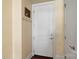 Bright entryway featuring a white door with coat hooks and dark wood flooring at 4620 Piedmont Row Dr # 308, Charlotte, NC 28210