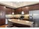 Spacious kitchen with stainless steel appliances, granite countertops, and ample dark wood cabinetry at 4620 Piedmont Row Dr # 308, Charlotte, NC 28210