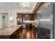Gourmet kitchen featuring stainless appliances, granite countertops, and rich dark wood cabinetry at 4620 Piedmont Row Dr # 308, Charlotte, NC 28210
