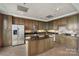 Well-equipped kitchen featuring stainless steel appliances, dark wood cabinets, and spacious island at 4620 Piedmont Row Dr # 308, Charlotte, NC 28210