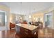 Open-concept living space featuring an island with granite countertop and a view into the adjacent dining and living areas at 4620 Piedmont Row Dr # 308, Charlotte, NC 28210