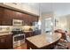 Stylish kitchen with granite island, stainless appliances, dark cabinets, and modern lighting at 4620 Piedmont Row Dr # 308, Charlotte, NC 28210