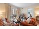 Inviting living room with balcony access, an orange sofa, and a TV, seamlessly connecting to a cozy bedroom at 4620 Piedmont Row Dr # 308, Charlotte, NC 28210