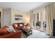 A comfortable living room featuring a balcony, an orange sofa, and an artful painting on the wall at 4620 Piedmont Row Dr # 308, Charlotte, NC 28210