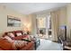 Relaxing living room with an orange sofa and access to a balcony with outdoor seating at 4620 Piedmont Row Dr # 308, Charlotte, NC 28210