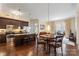 Open-concept kitchen, dining, and living area with dark wood floors and balcony access at 4620 Piedmont Row Dr # 308, Charlotte, NC 28210