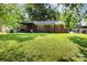 Wide view of the backyard with lush lawn and back porch at 4924 Farm Pond Ln, Charlotte, NC 28212