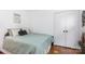Comfortable bedroom with hardwood floors, a cozy bed, and natural light from the window at 4924 Farm Pond Ln, Charlotte, NC 28212