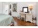 Sunlit bedroom featuring hardwood floors, a vanity area, and a peaceful atmosphere at 4924 Farm Pond Ln, Charlotte, NC 28212