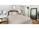 Bright bedroom featuring hardwood floors, plush bedding, and a vanity area at 4924 Farm Pond Ln, Charlotte, NC 28212