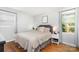 Serene bedroom with plush bedding, hardwood floors, and a window offering scenic views at 4924 Farm Pond Ln, Charlotte, NC 28212