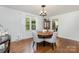 Inviting dining room with a round table, elegant chandelier, and views of the outdoors at 4924 Farm Pond Ln, Charlotte, NC 28212