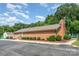 Nice brick building with a trimmed yard and dark asphalt parking in front, set against a blue sky and white clouds at 4924 Farm Pond Ln, Charlotte, NC 28212