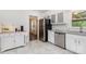 Bright eat-in kitchen with white cabinetry, stainless steel appliances, and sleek countertops at 4924 Farm Pond Ln, Charlotte, NC 28212