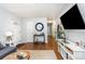 Spacious living room with hardwood floors, modern furniture, and a seamless flow to other areas at 4924 Farm Pond Ln, Charlotte, NC 28212