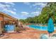Community swimming pool featuring lounge chairs, patio umbrellas, picnic tables, flowers and shade at 4924 Farm Pond Ln, Charlotte, NC 28212