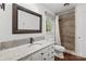 Bathroom featuring a walk-in shower with neutral colored tile and a granite countertop with white cabinets at 5016 Celeste Ct, Charlotte, NC 28270