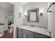 Bright bathroom featuring granite countertops and a neutral colored vanity with gray walls and tiled floors at 5016 Celeste Ct, Charlotte, NC 28270