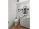 Charming half bathroom features stylish wainscotting, a marble countertop, and modern light fixtures at 5016 Celeste Ct, Charlotte, NC 28270