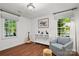 Bedroom with hardwood floors, natural light, a reading chair, and a decorative painting at 5016 Celeste Ct, Charlotte, NC 28270