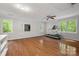 Large bonus room featuring a treadmill, hardwood floors, bright windows, and white walls at 5016 Celeste Ct, Charlotte, NC 28270