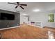 Spacious bonus room with hardwood floors, tv, bright windows and neutral paint scheme at 5016 Celeste Ct, Charlotte, NC 28270