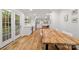Inviting dining room features hardwood floors, a large wooden table, access to the backyard and backyard views at 5016 Celeste Ct, Charlotte, NC 28270