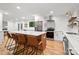 Spacious kitchen with island, modern stainless-steel appliances, white cabinets, and hardwood flooring at 5016 Celeste Ct, Charlotte, NC 28270
