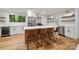 Modern kitchen with white cabinets, stainless steel appliances, a center island, and hardwood floors at 5016 Celeste Ct, Charlotte, NC 28270