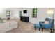 Spacious living room with plush seating, a blue accent chair, large windows, and neutral décor at 5016 Celeste Ct, Charlotte, NC 28270