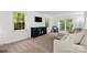 Bright living room with plush carpeting, white walls, large windows, and a comfortable seating area at 5016 Celeste Ct, Charlotte, NC 28270
