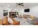 Inviting living room boasts a brick fireplace, hardwood floors, and comfortable, stylish furniture at 5016 Celeste Ct, Charlotte, NC 28270