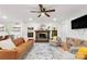 Open concept living room shows a fireplace, stylish furniture, hardwood floors, and backyard views at 5016 Celeste Ct, Charlotte, NC 28270