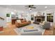 Bright, open concept living room adjacent to kitchen, featuring hardwood floors, and comfortable seating at 5016 Celeste Ct, Charlotte, NC 28270