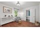 Bright sitting room with a patterned chair, a small window, hardwood floors, and white walls at 5016 Celeste Ct, Charlotte, NC 28270