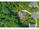 Aerial view of a private home, showcasing a large backyard patio, mature trees, and driveway at 5044 Dockside Ct, Matthews, NC 28104