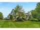 Expansive backyard featuring lush greenery and an outdoor seating area at 5044 Dockside Ct, Matthews, NC 28104