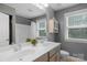 Bathroom showcasing dual sinks, modern vanity, and cabinet storage with neutral gray walls at 5044 Dockside Ct, Matthews, NC 28104